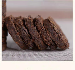 MOORCHOCO single mini Pu-erh cake close-up highlighting compact pressed form