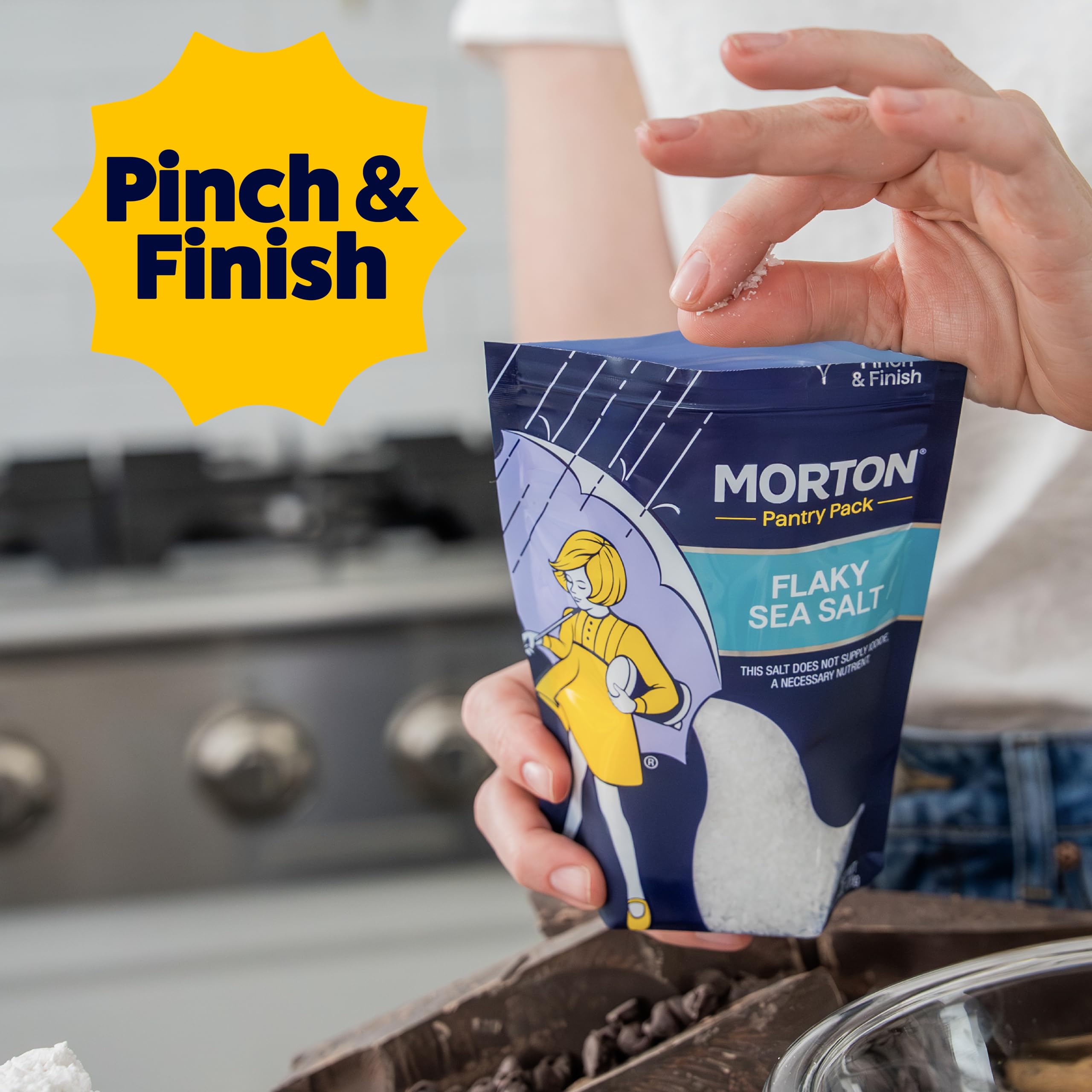 Morton flaky sea salt being sprinkled on steak for finishing crunch and flavor boost