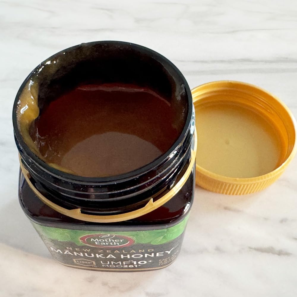 Hand holding Mother Earth 250g jar to show real-world size and convenience