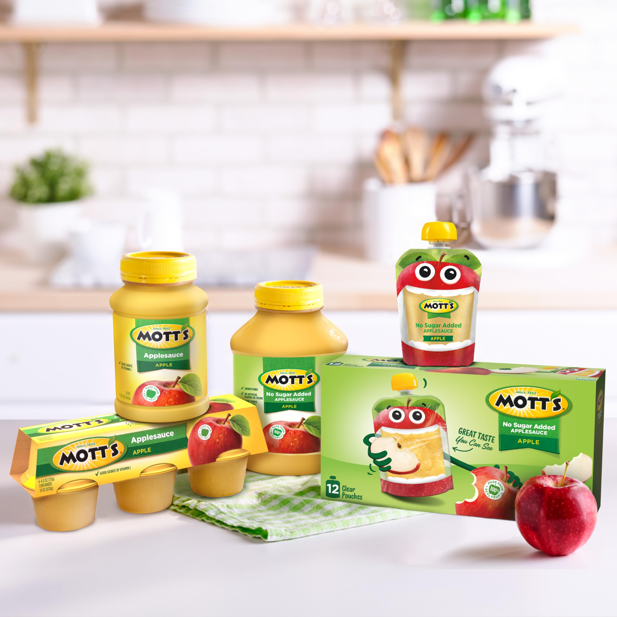 Mott's spoon revealing applesauce texture to show smoothness and real-fruit appeal