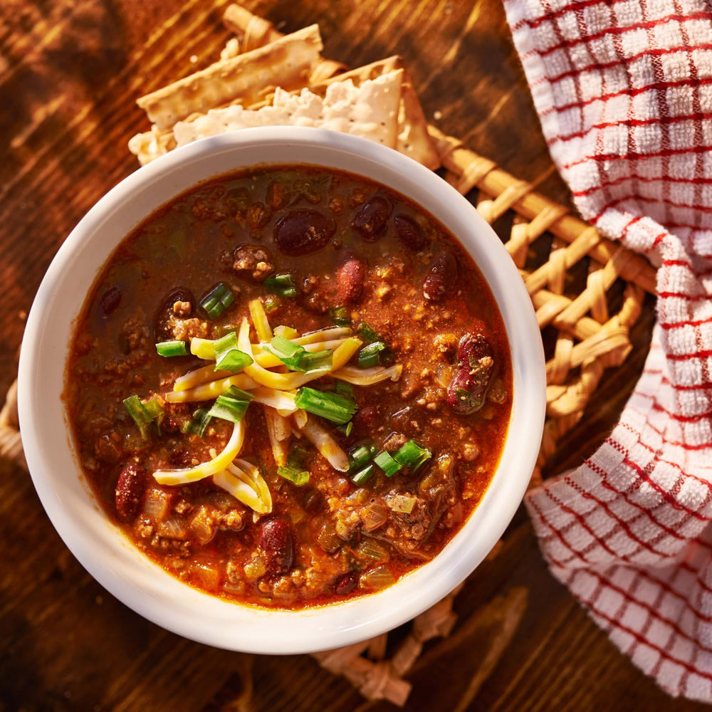 Mrs. Dash seasoning added to a bowl of chili enhancing taste without salt