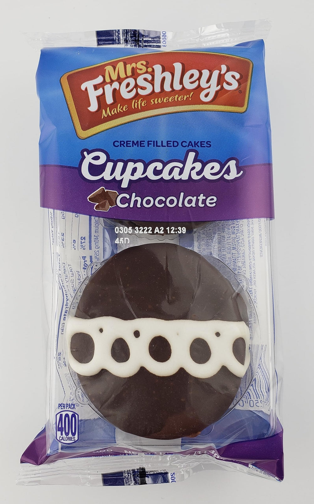 Mrs. Freshley's cupcake in hand demonstrating portion size and on-the-go snack benefit