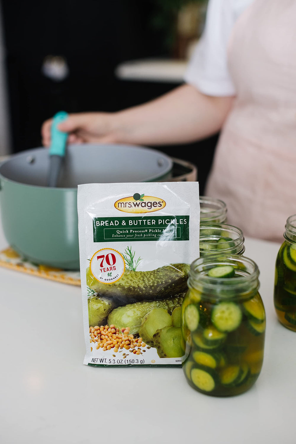 Mrs. Wages packets beside canning jars showing yield and batch-size benefit