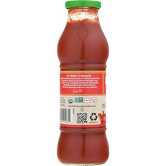 Mutti passata being poured into a bowl demonstrating smooth texture and cooking ease