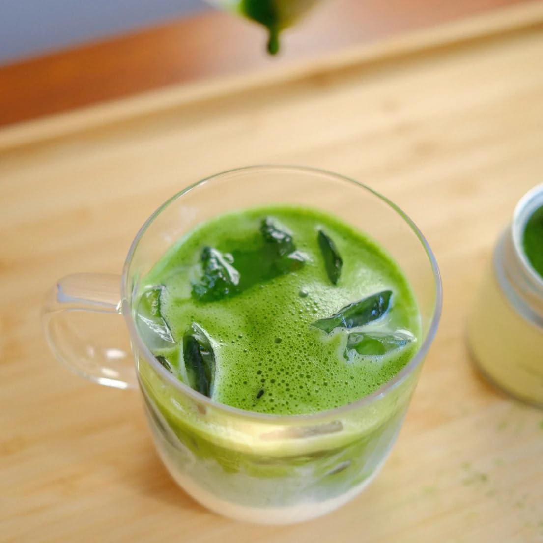 Nami Matcha next to teaspoon to show 30g tin size and serving