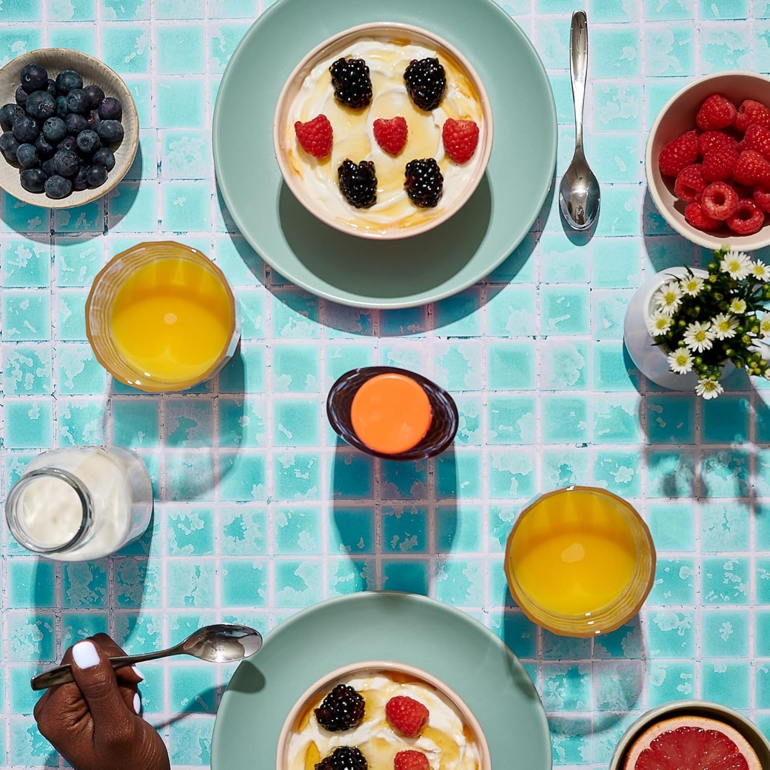 Hand holding Nature Nate's 8 oz bottle to show scale and portability for on-the-go use