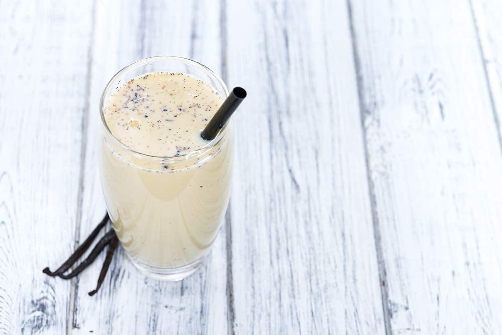 Native Vanilla farmer with vanilla beans highlighting ethical sourcing