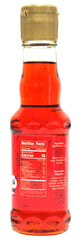 Natural Plus Green top label close-up showing bottle cap and brand clarity benefit