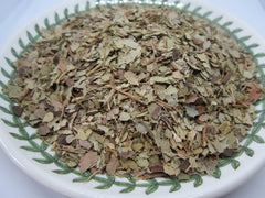 Nature Tea leaves beside a measuring spoon for scale showing 4 oz portion convenience