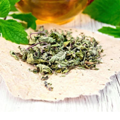 NatureJam crushed mint steeping in teacup to provide quick aromatic mint tea infusion