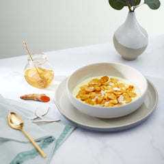 Nature's Path milk pouring into cereal turning bowl golden to illustrate serving idea