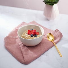 Bowl of prepared Nature's Path oatmeal topped with fruit showing easy nutritious meal