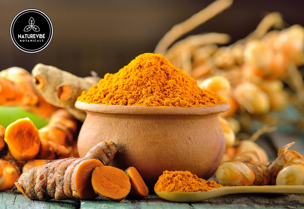Naturevibe Botanicals wooden spoon heaped with turmeric powder demonstrating easy scooping for recipes benefit