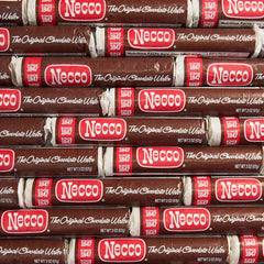 Closeup of an individual Necco roll revealing chocolate wafers and secure individual wrapper for freshness