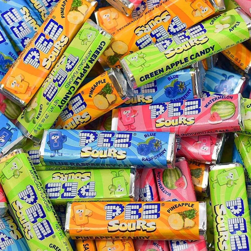 Needzo filled PEZ dispensers in use, demonstrating easy refilling and fun serving