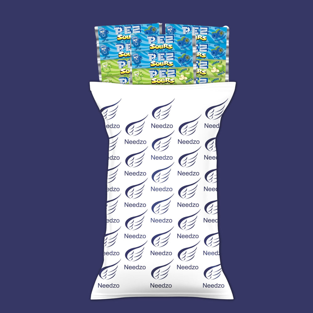 Needzo flavor labels and wrappers laid out, showing assorted green apple and berry options