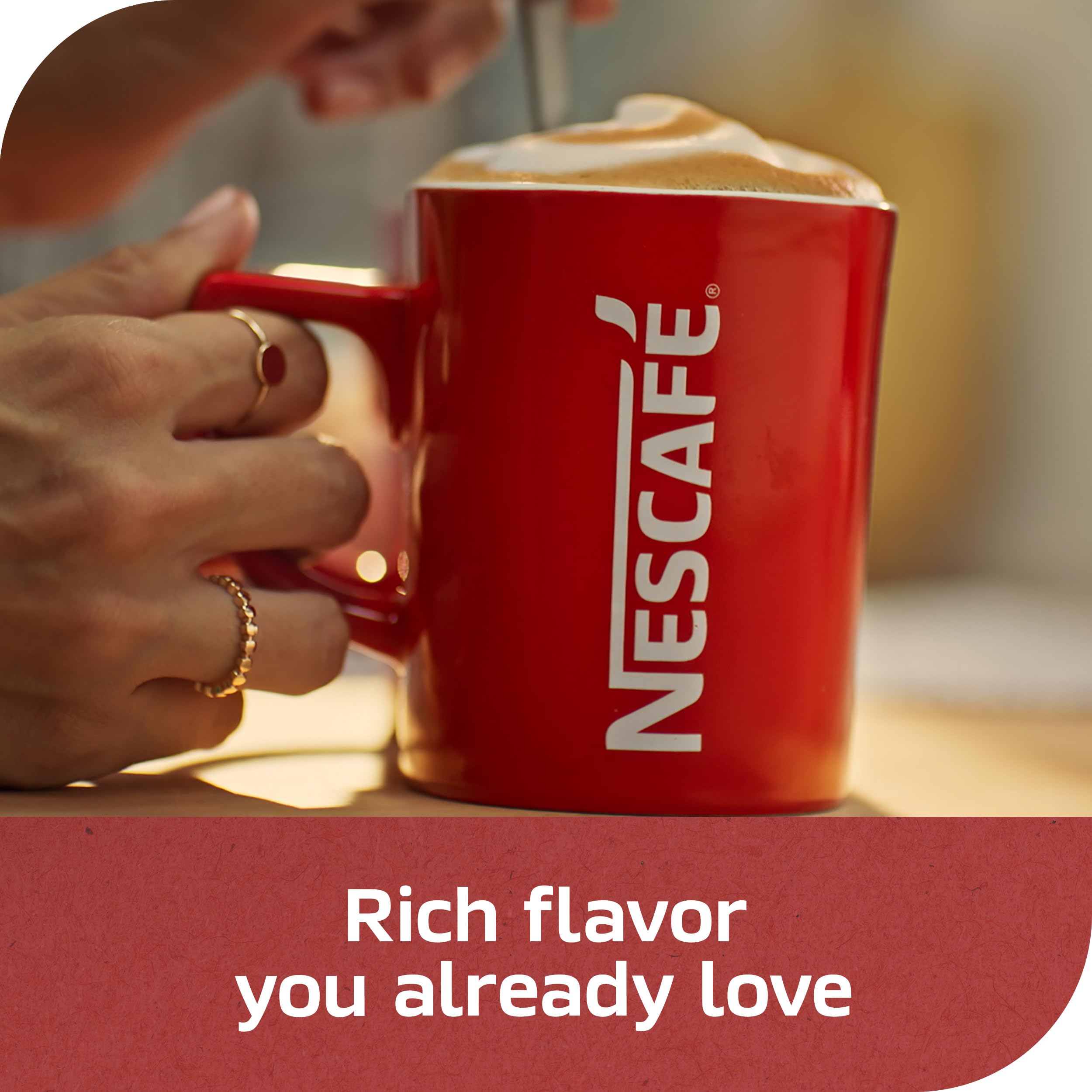 nescafe cup with milk pour, dark roast holds flavor with cream
