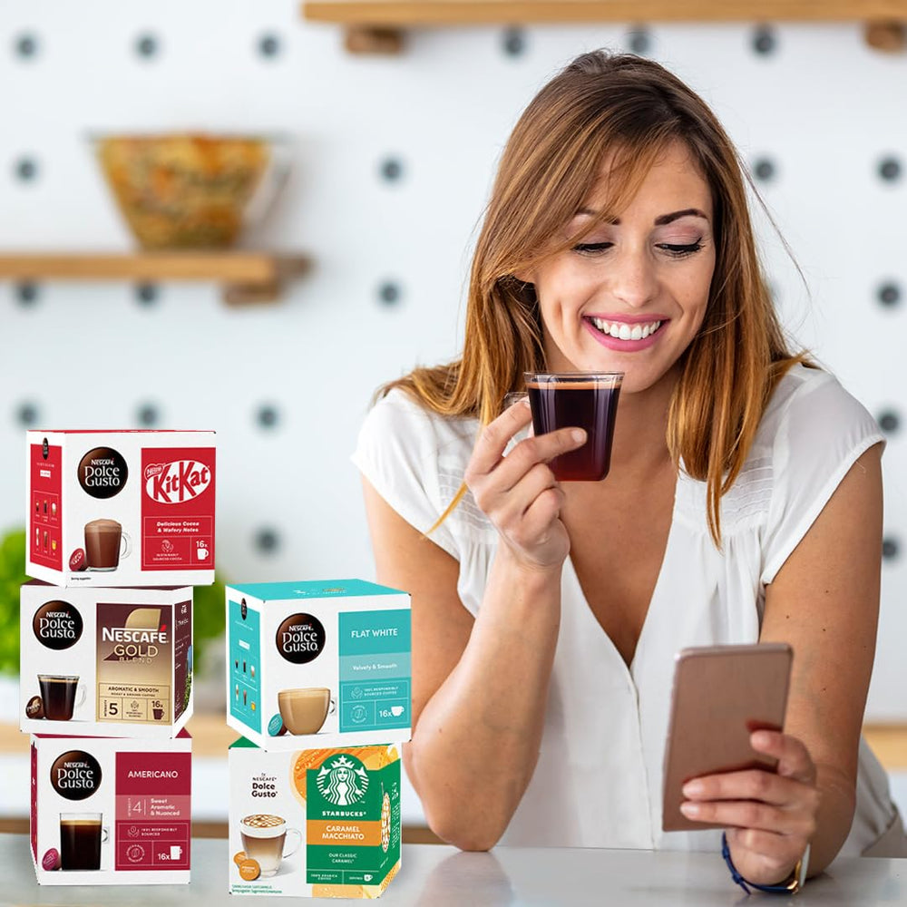 Nescafé Dolce Gusto capsule beside hand for scale showing single-serve portability