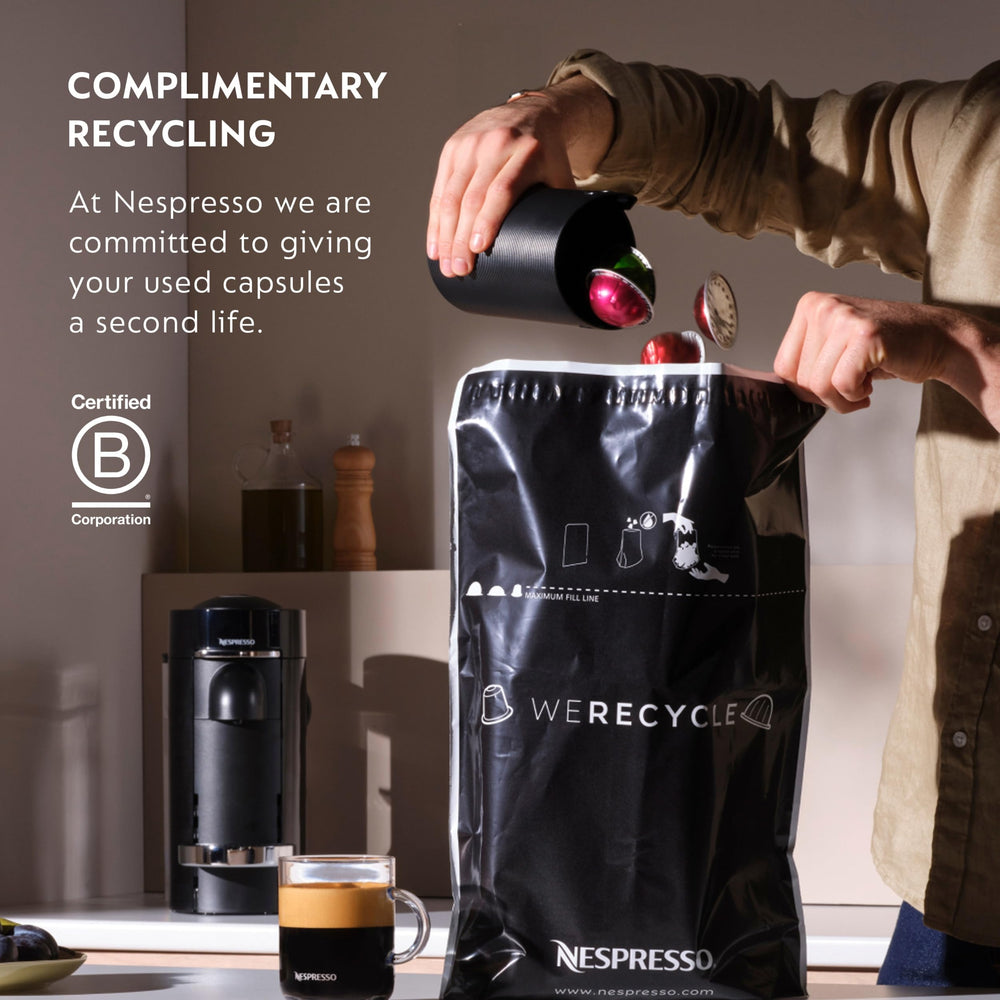 Nespresso Il Caffè capsule next to hand for scale showing portion convenience