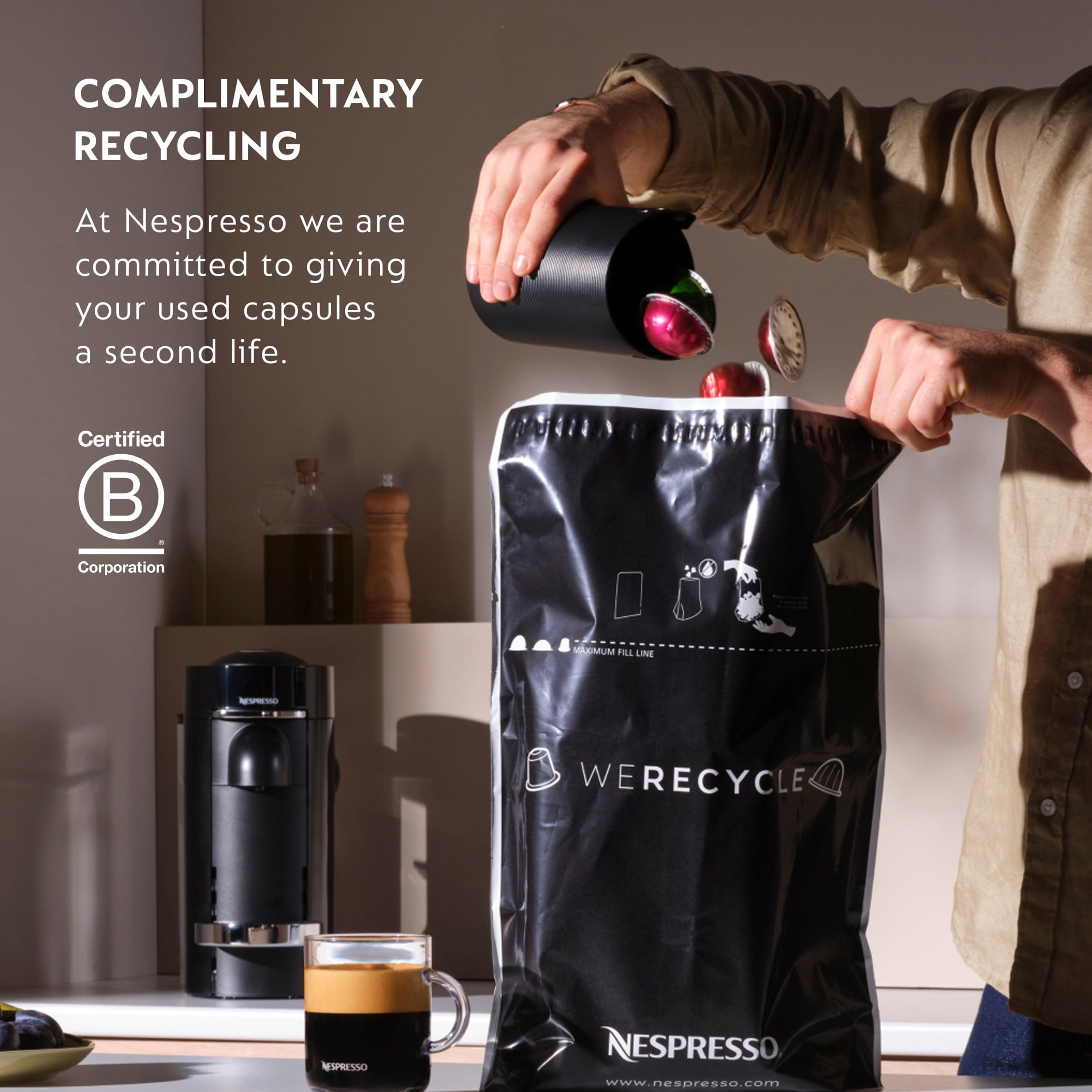 Nespresso capsule next to hand for scale showing compact convenience