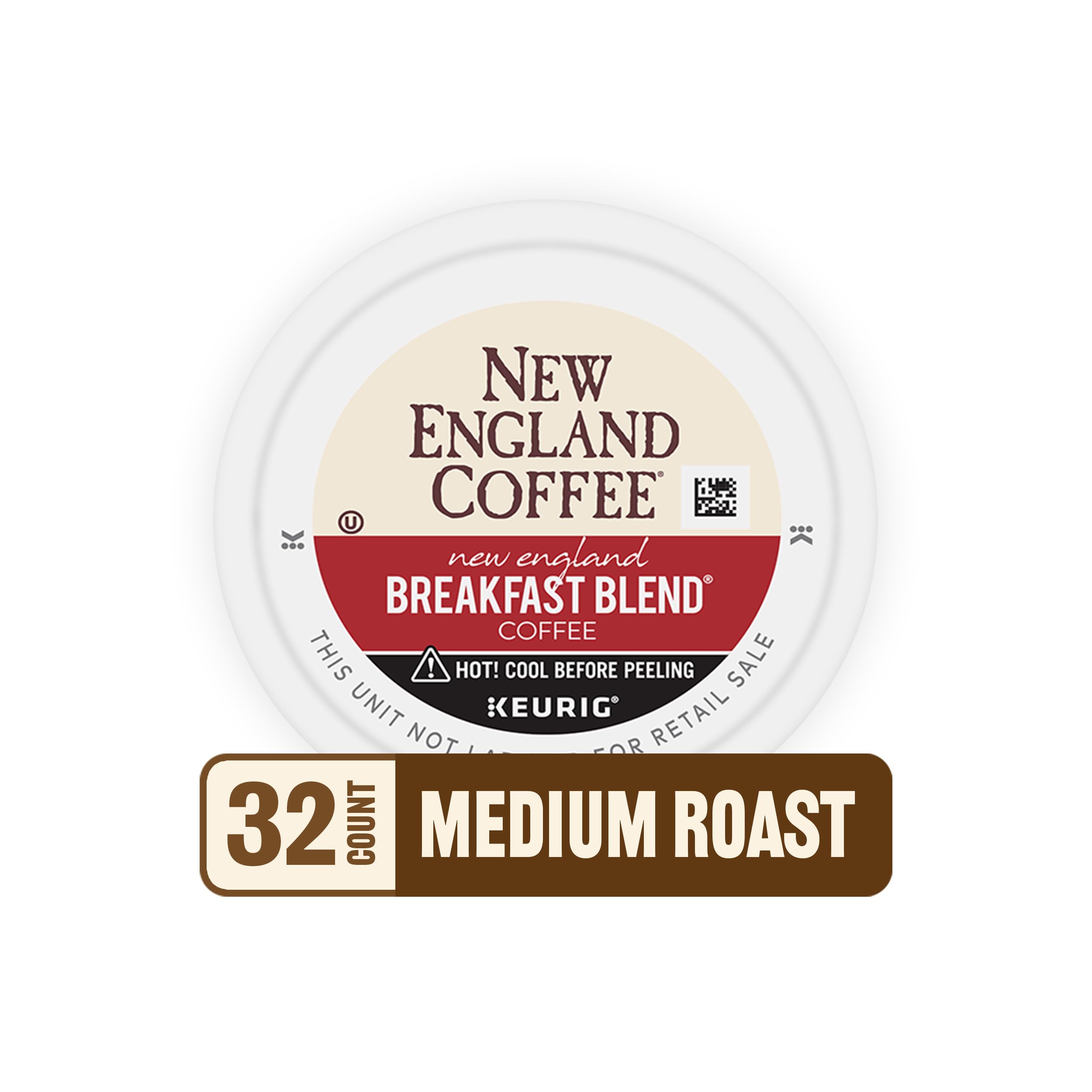 New England Coffee pods beside a hand for scale illustrating compact, travel-friendly size