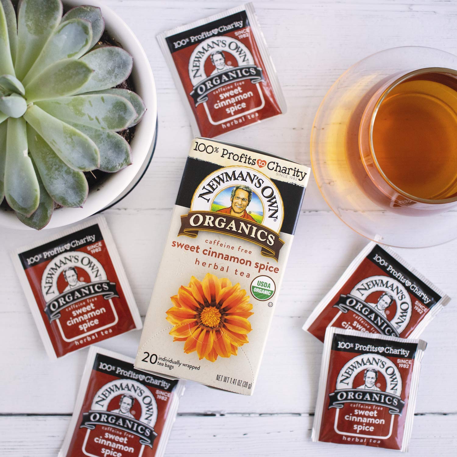 Newman's Own six-box pack beside a ruler, shows compact supply for sharing