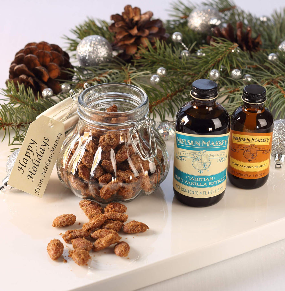 Nielsen-Massey bottle near freshly baked almond cookies illustrating rich flavor enhancement