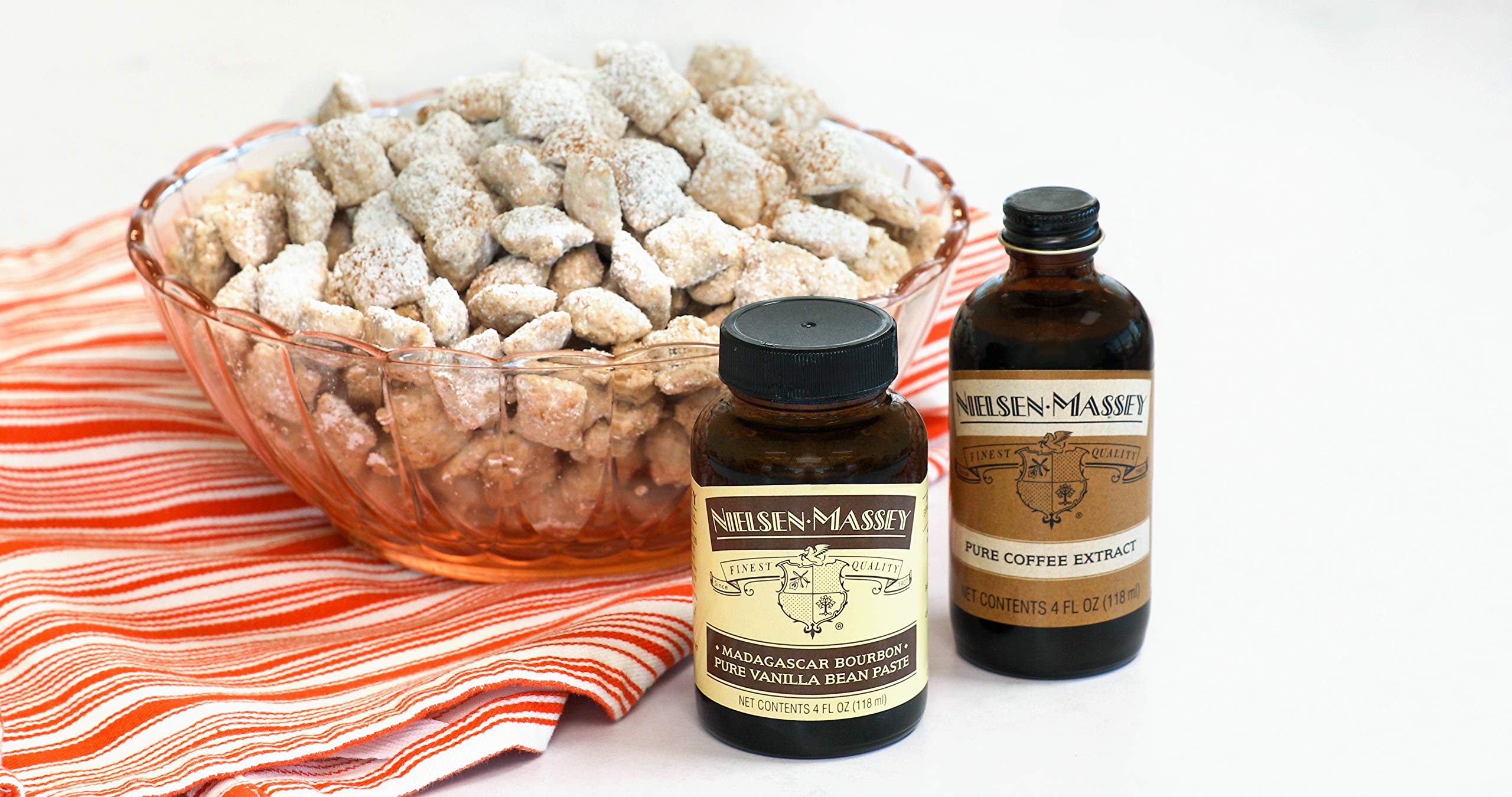 Coffee beans and bottle together showing Nielsen-Massey’s sourced-beans authenticity