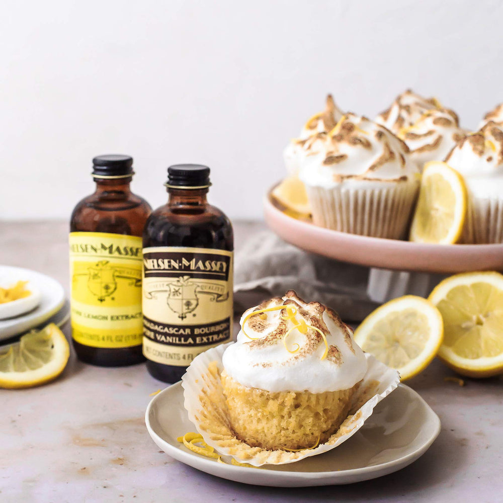 pouring lemon extract into measuring spoon to show Nielsen-Massey precise usage benefit