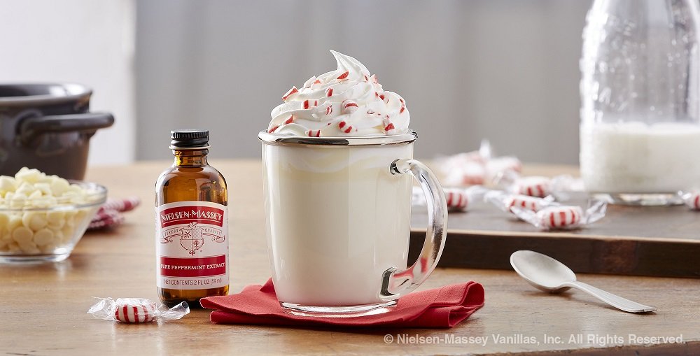 Nielsen-Massey peppermint extract being poured into a bowl demonstrating easy dosing benefit