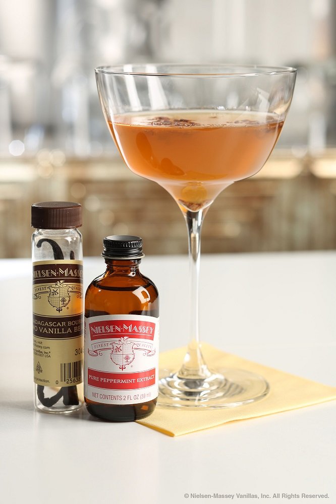 Nielsen-Massey peppermint extract beside a teaspoon for size comparison and portion control benefit