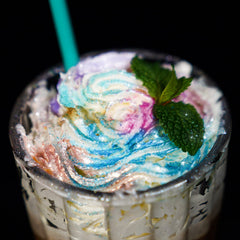 Sparkling cocktail with NiHome blue glitter swirling to create eye-catching beverage visuals