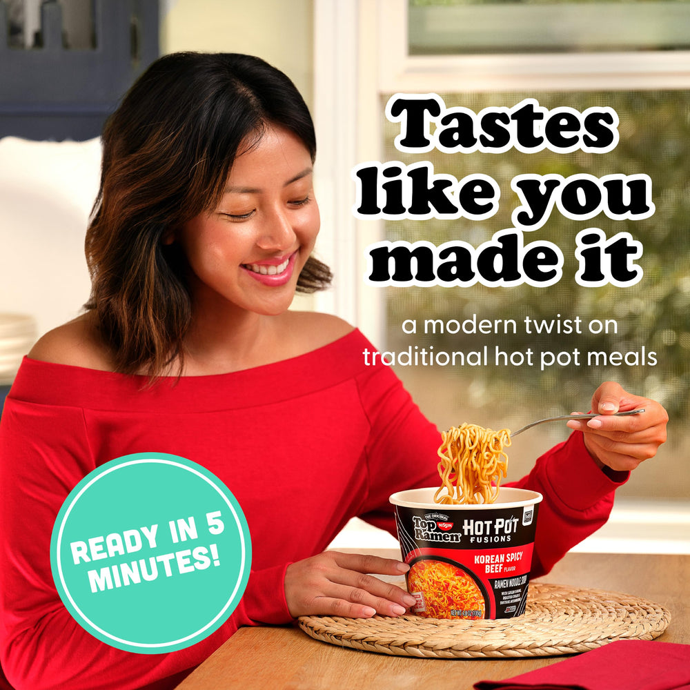 NISSIN open bowl with noodles and toppings indicating hearty ingredients