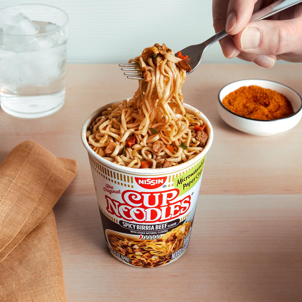 NISSIN cup on desk beside laptop illustrating portable convenient meal