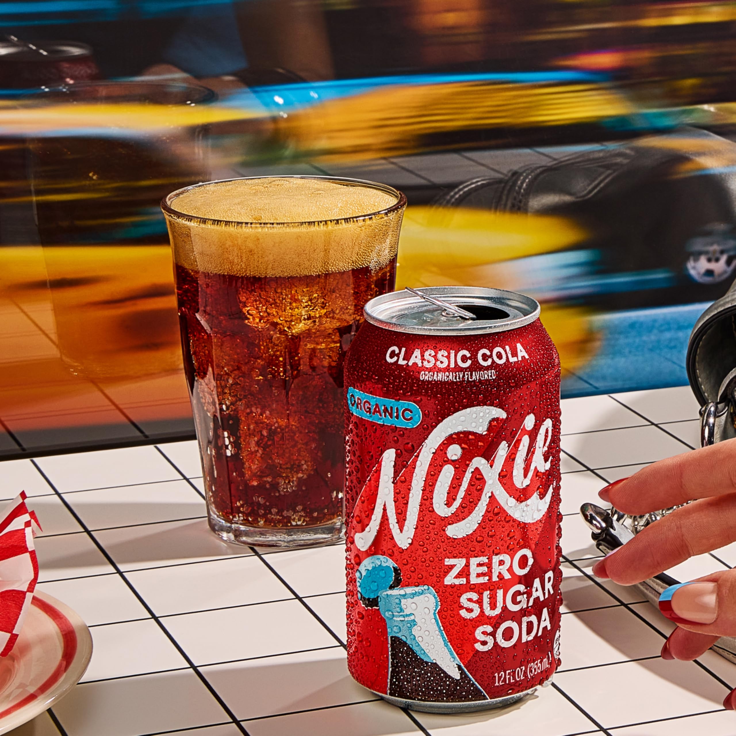 Nixie classic cola twelve-pack box on counter showing scale and convenience
