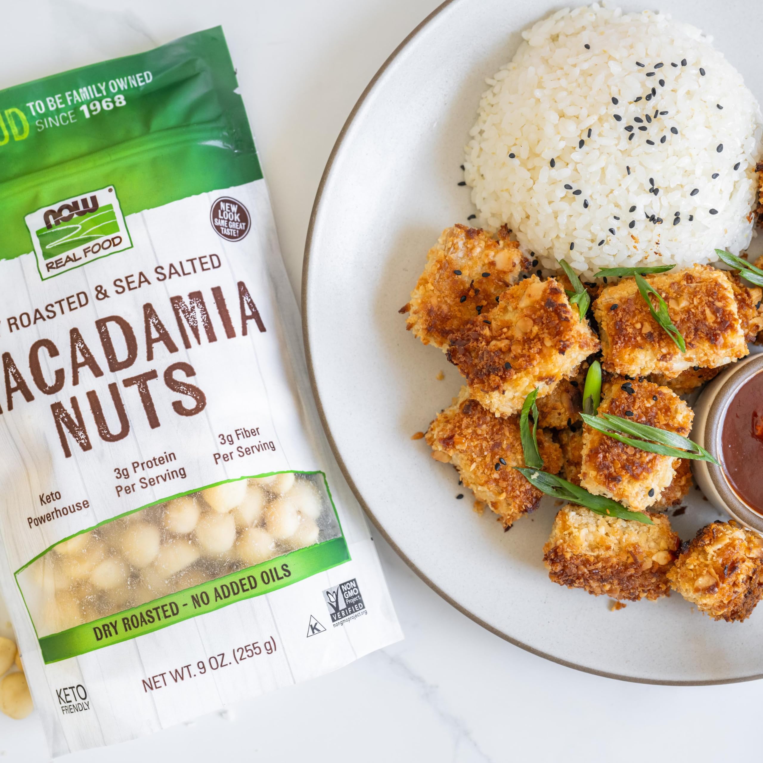 NOW Foods macadamias in a bowl on a kitchen counter showing ready-to-eat convenience