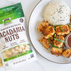 NOW Foods macadamias in a bowl on a kitchen counter showing ready-to-eat convenience