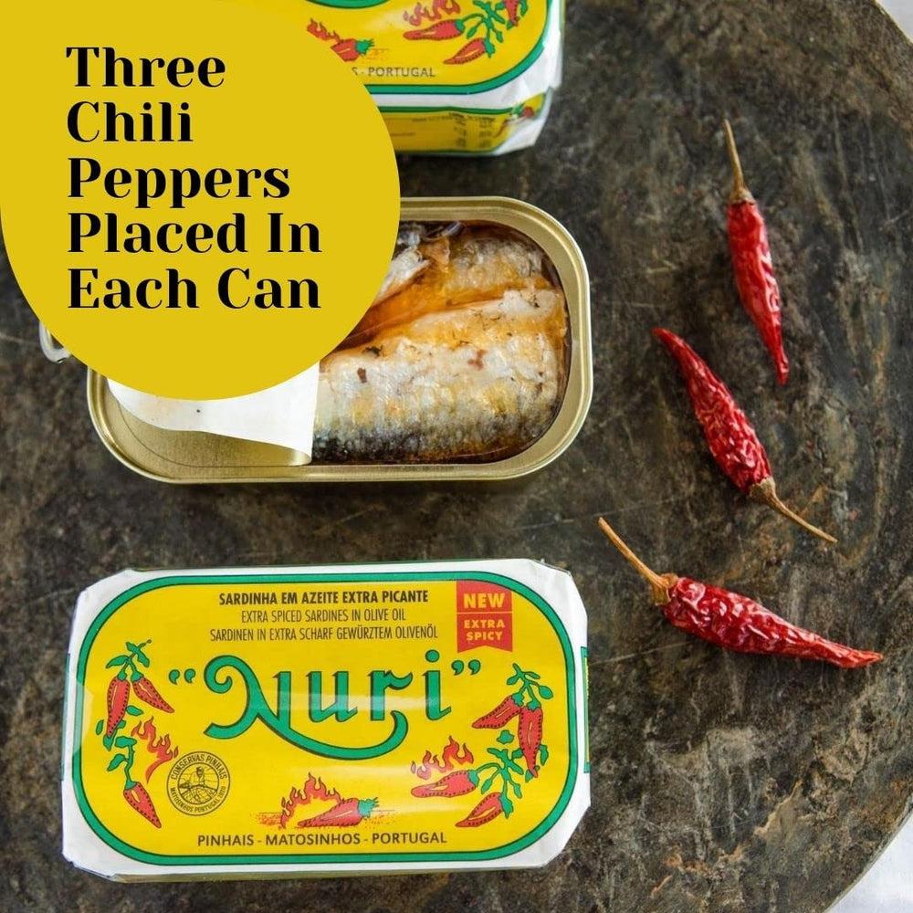 Nuri open can overhead revealing spiced sardines in olive oil