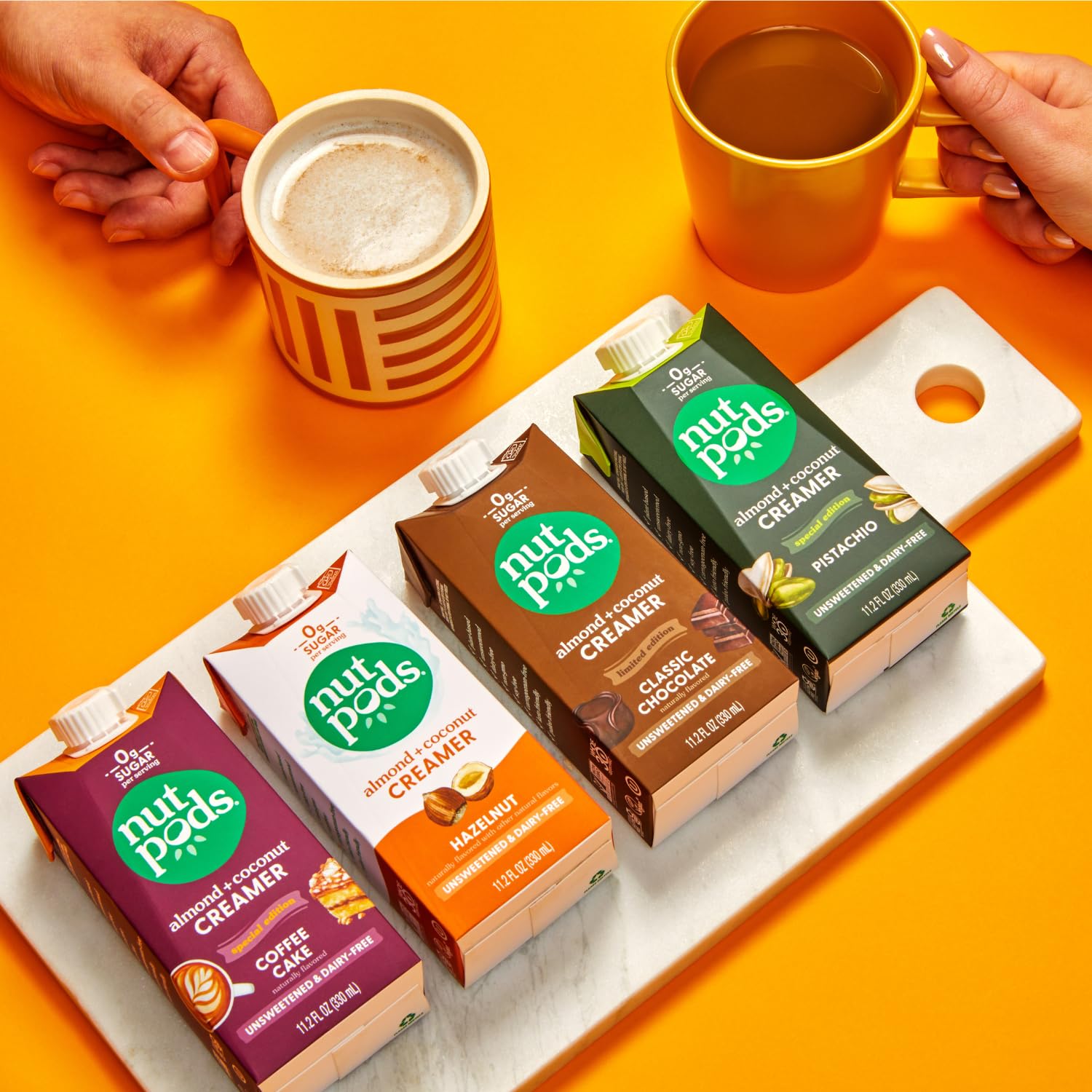 nutpods coffee cake creamer splashing into latte, suggests bakery-inspired warmth and creaminess
