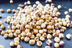 Nutural World open jar with roasted hazelnuts visible — natural ingredient clarity