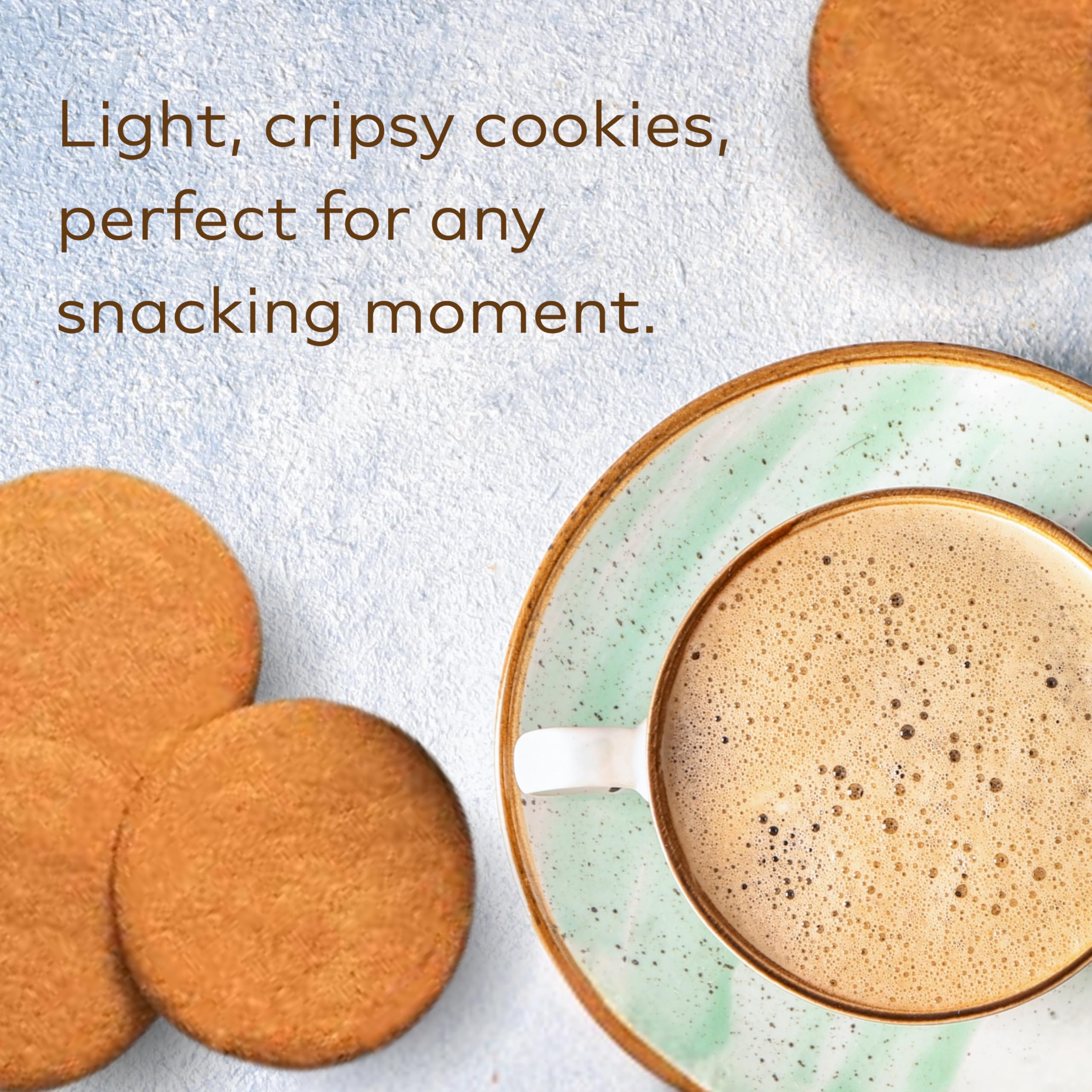 Nyakers cookies beside a coffee cup showing scale and serving suggestion