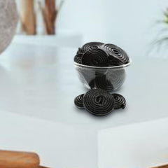 OBELYS licorice wheel beside a coin showing size and portioning ease