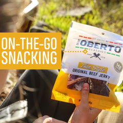 Oberto hand holding pouch, demonstrating easy portable snack benefit
