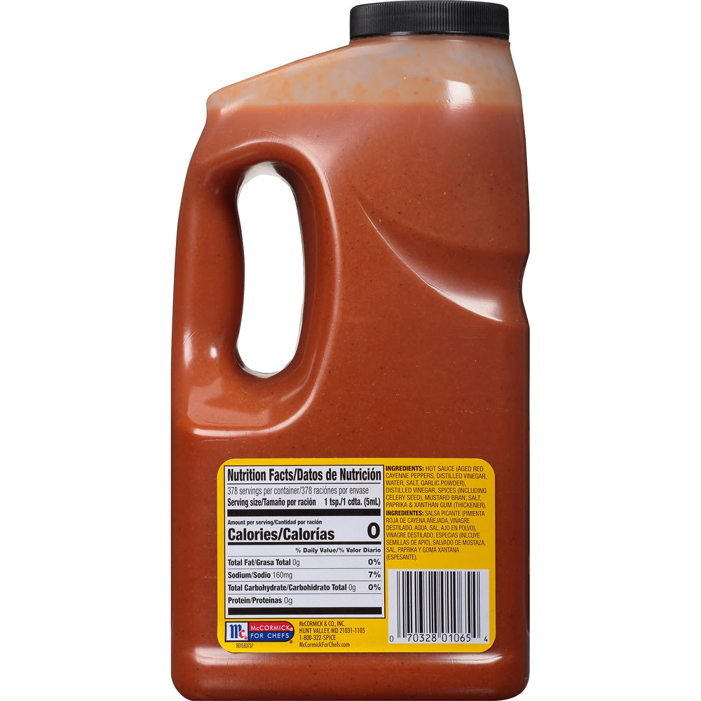OLD BAY sauce pouring from jug onto food, adding tangy heat and visible spice specks