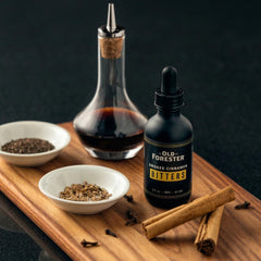Old Forester bitters being dashed into a cocktail to add warm cinnamon aroma and balanced spice