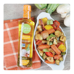 Oleico Creole bottle angled with visible rosemary and chile de árbol to add heat
