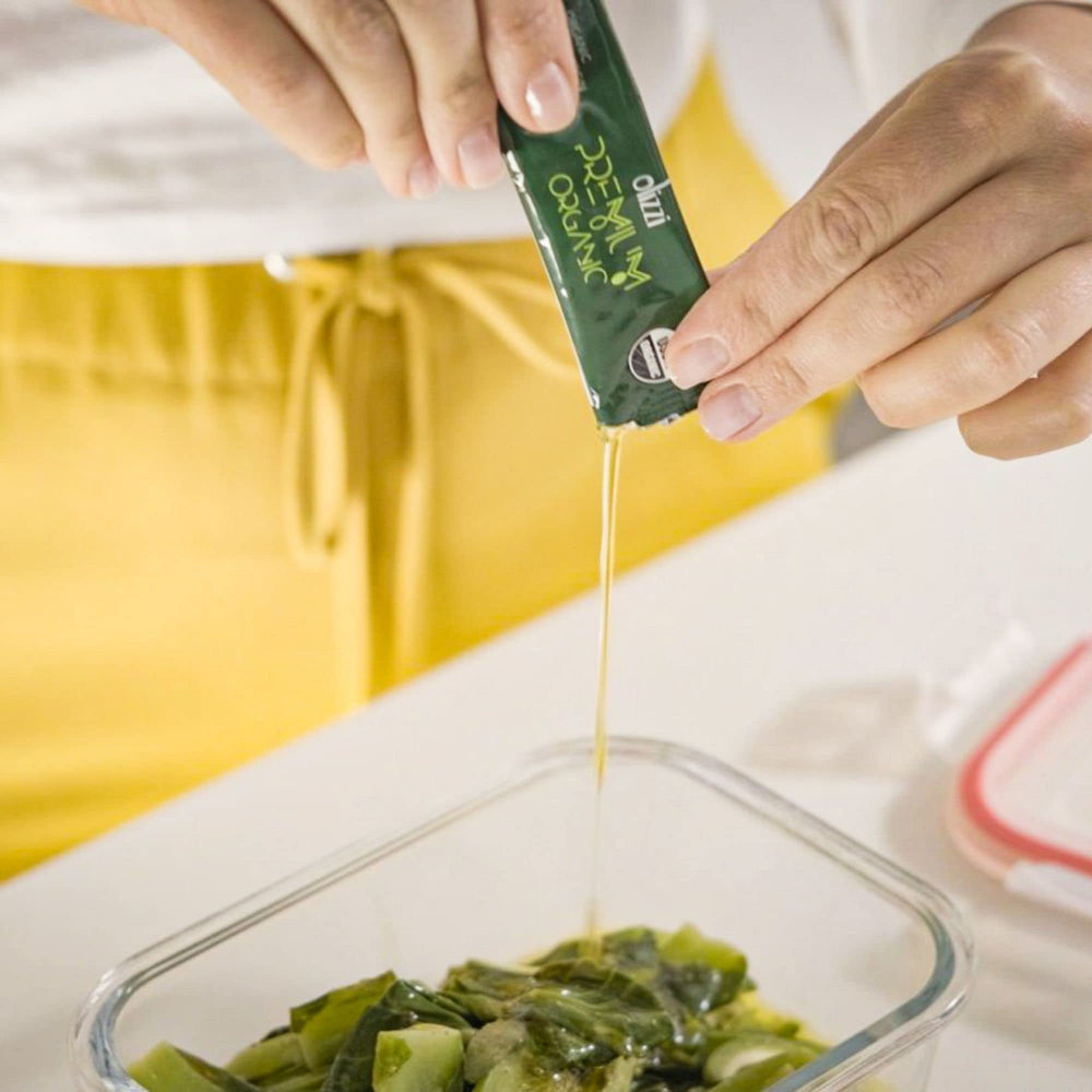 Olizzi texture drop on salad leaves showing olive oil sheen and fresh aroma
