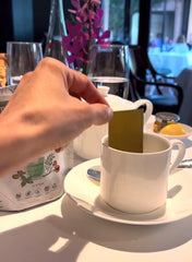 Olyxir dissolvable tea strip close-up on fingertip, quick-dissolve convenience