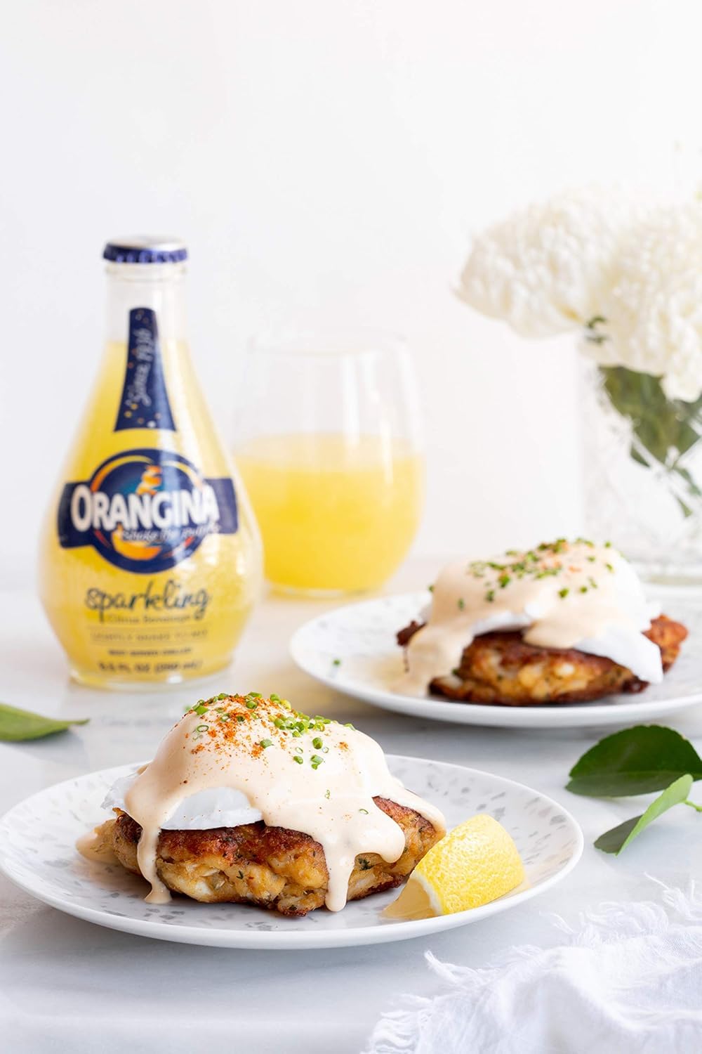 Orangina cans on party table with snacks, brand elevates social gatherings
