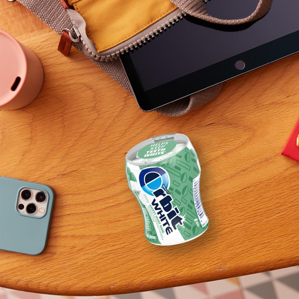 Orbit sweet mint bottle on a desk beside a notebook for workplace freshness